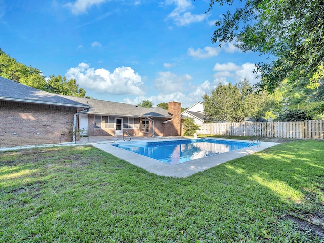 view of swimming pool with a yard and a patio area