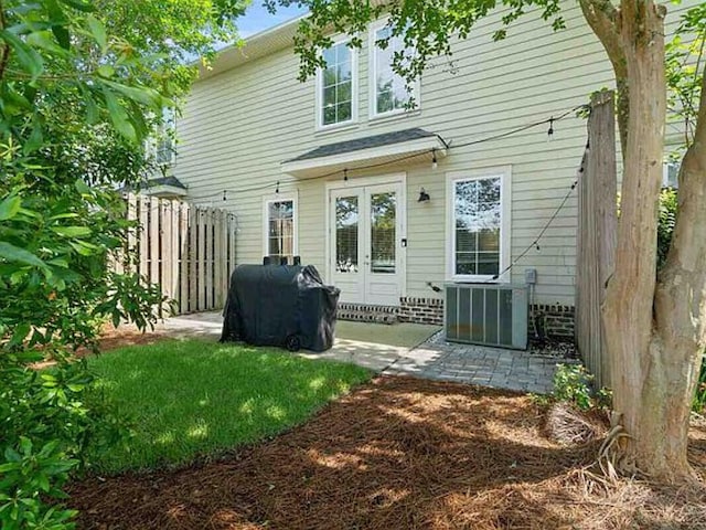 rear view of property with a patio area and central AC unit