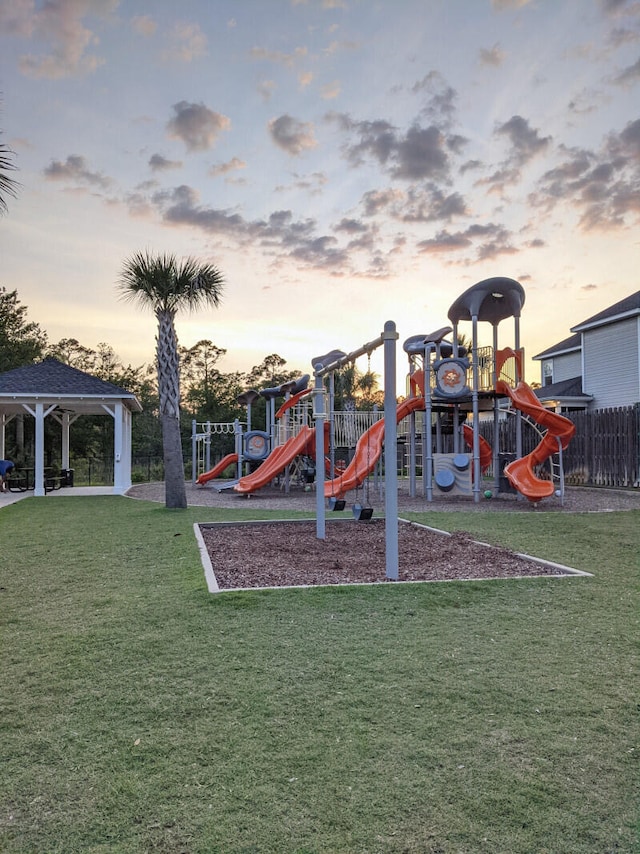 playground at dusk with a yard and a gazebo