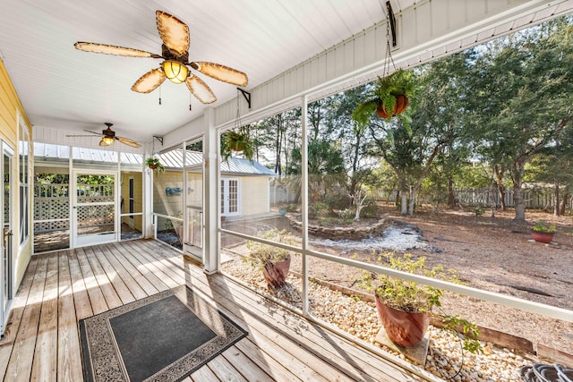 unfurnished sunroom with ceiling fan