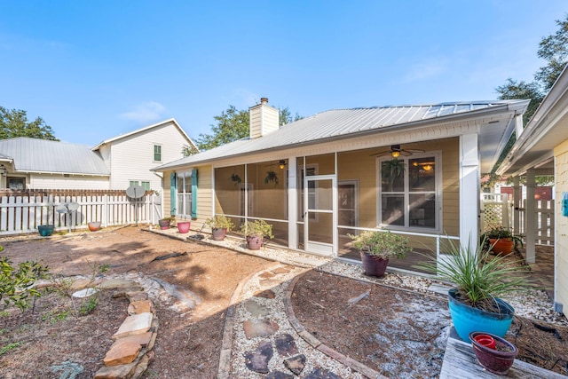 rear view of property with ceiling fan