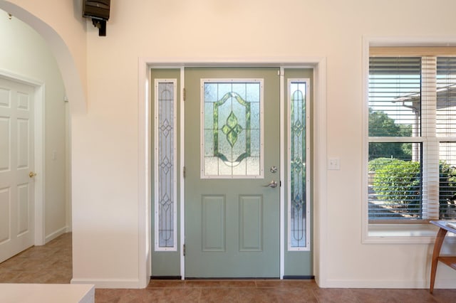 tiled foyer featuring a wealth of natural light