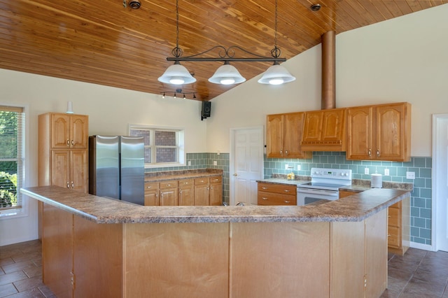 kitchen featuring backsplash, white range with electric stovetop, pendant lighting, a kitchen island, and stainless steel refrigerator