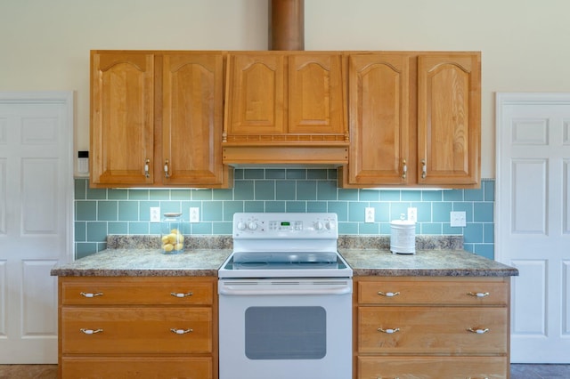 kitchen with electric range and backsplash