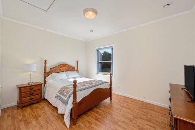 bedroom featuring light wood-type flooring and ornamental molding