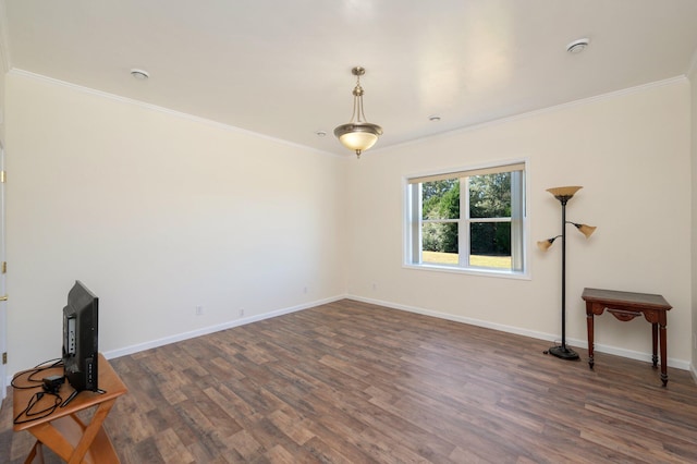 unfurnished living room with dark hardwood / wood-style flooring and ornamental molding