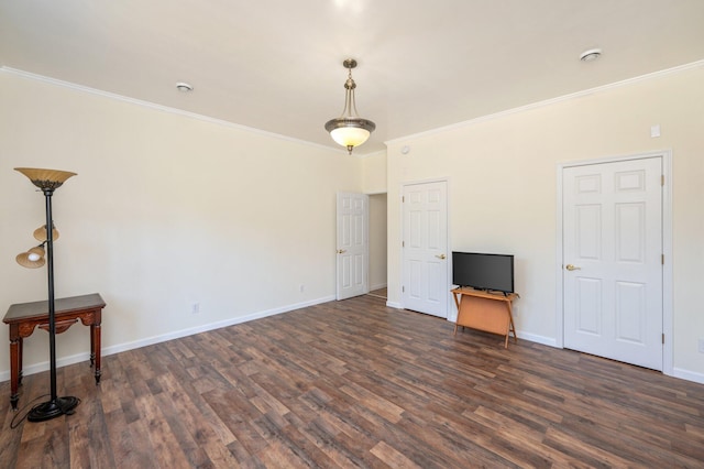 unfurnished living room with dark hardwood / wood-style flooring and ornamental molding