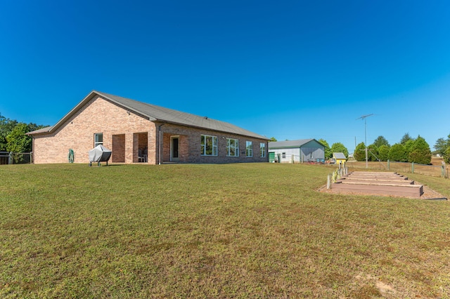 back of property featuring a lawn