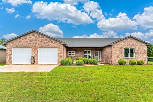 ranch-style home with a garage and a front lawn