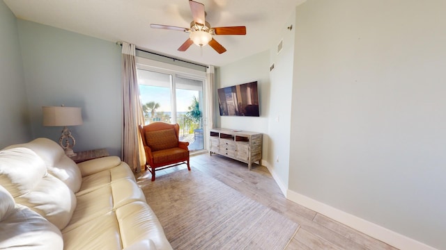 living room featuring light hardwood / wood-style flooring and ceiling fan