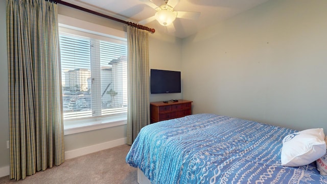 bedroom with multiple windows, light colored carpet, and ceiling fan