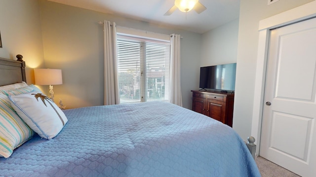 bedroom featuring light carpet, a closet, and ceiling fan