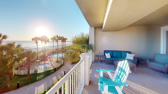 balcony with outdoor lounge area and a water view