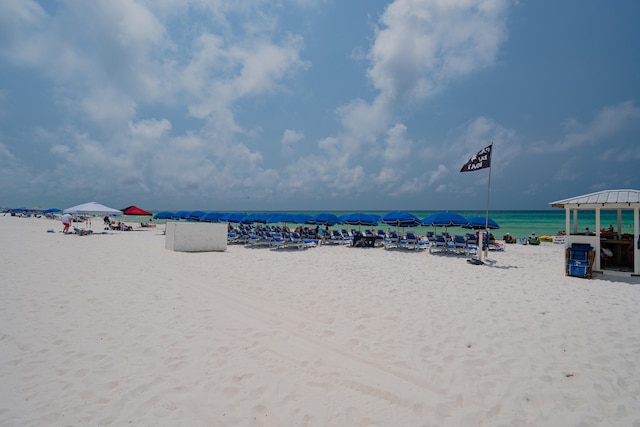 water view featuring a gazebo and a beach view