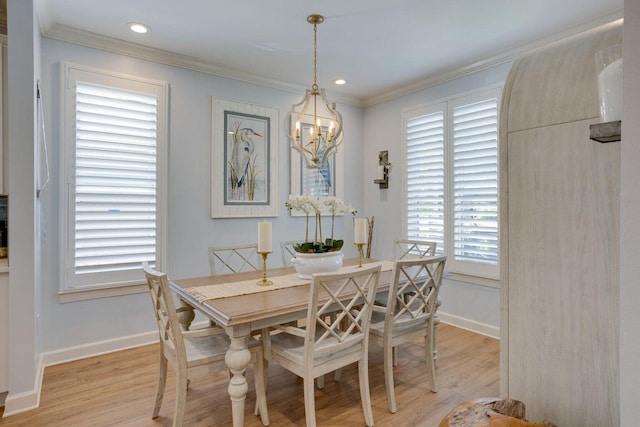 dining area with an inviting chandelier, a wealth of natural light, and light hardwood / wood-style flooring