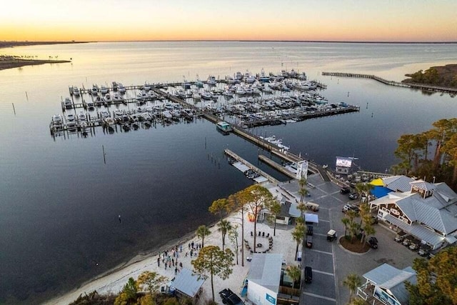 aerial view at dusk featuring a water view