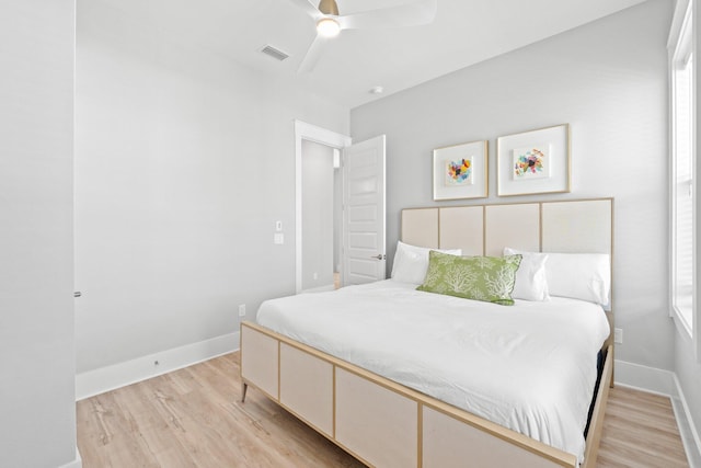 bedroom with light hardwood / wood-style floors and ceiling fan