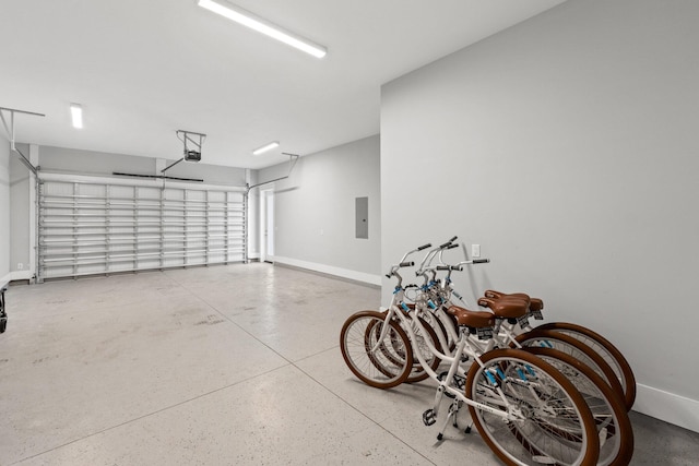 garage with a garage door opener and electric panel