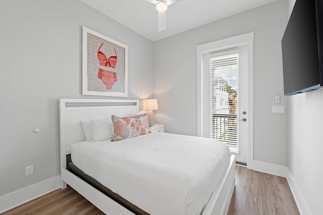 bedroom with access to exterior, hardwood / wood-style flooring, and ceiling fan