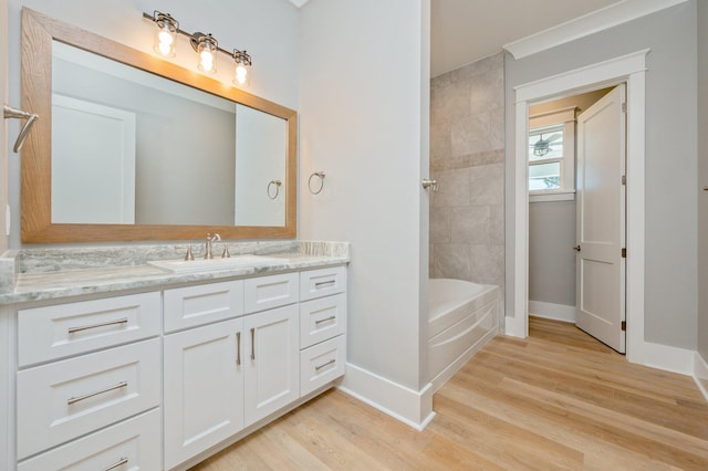 bathroom featuring vanity, wood-type flooring, and tiled shower / bath combo