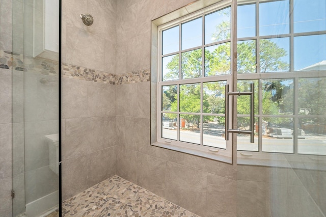 bathroom with tiled shower