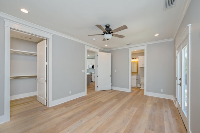 unfurnished bedroom with ensuite bath, ceiling fan, light wood-type flooring, ornamental molding, and a closet