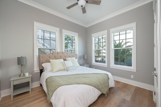 bedroom featuring ceiling fan, crown molding, and light wood-type flooring