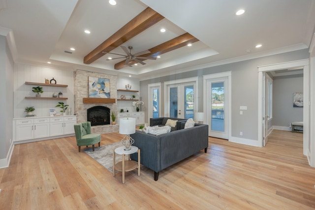 living room with french doors, light hardwood / wood-style flooring, ceiling fan, a fireplace, and beam ceiling