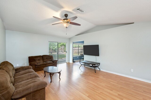 living room with a textured ceiling, ceiling fan, light hardwood / wood-style flooring, and lofted ceiling