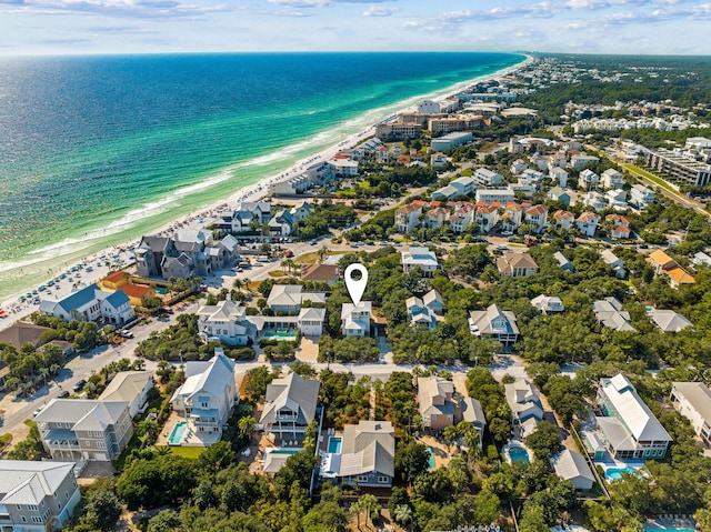 bird's eye view with a water view and a beach view