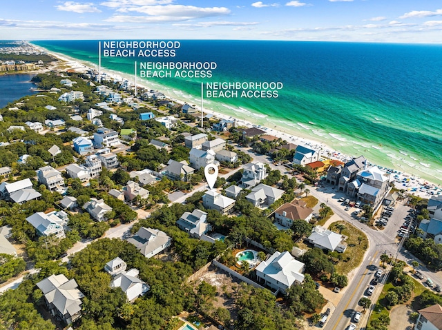 bird's eye view with a water view and a view of the beach