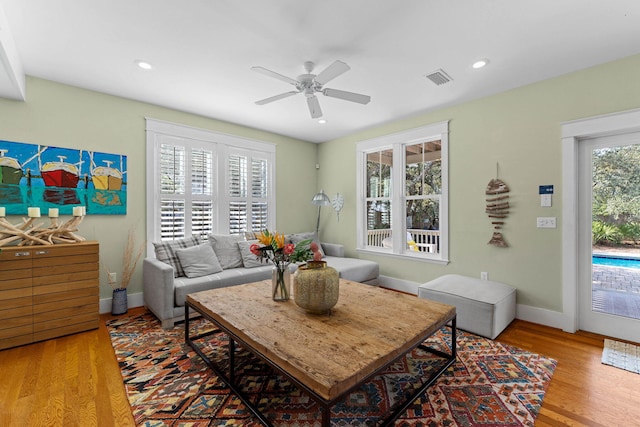 living room featuring hardwood / wood-style floors, plenty of natural light, and ceiling fan