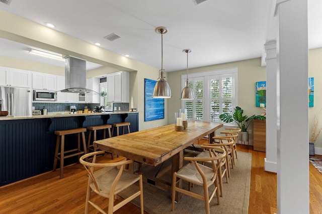 dining space featuring light hardwood / wood-style floors