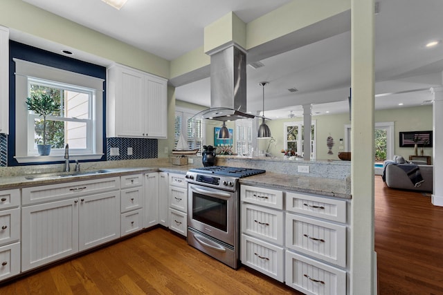 kitchen featuring white cabinetry, stainless steel gas stove, wood-type flooring, and island range hood