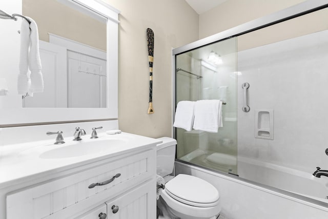 full bathroom featuring vanity, toilet, and bath / shower combo with glass door