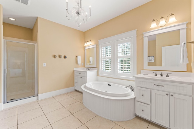 bathroom with vanity, an inviting chandelier, plus walk in shower, and tile patterned flooring