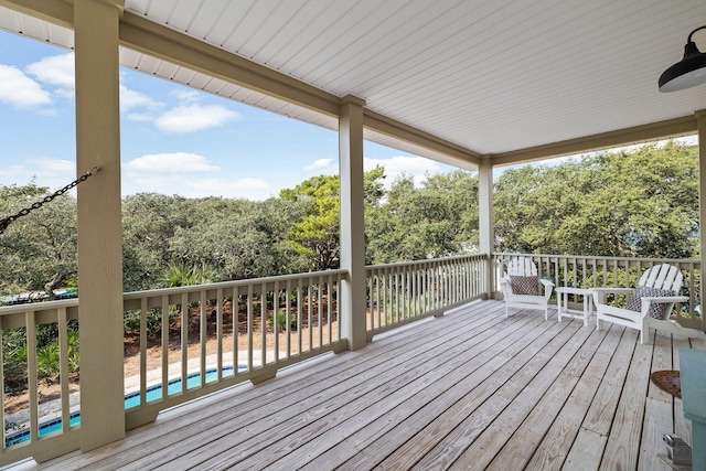 wooden terrace with a swimming pool