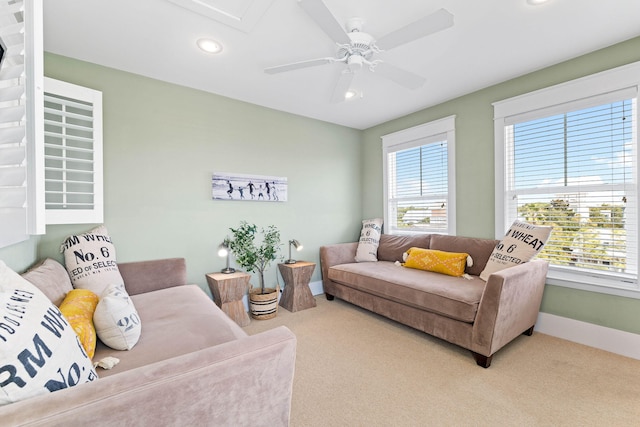 carpeted living room with ceiling fan and plenty of natural light