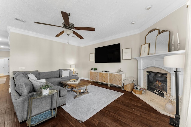 living room with ornamental molding, a textured ceiling, dark hardwood / wood-style floors, and ceiling fan