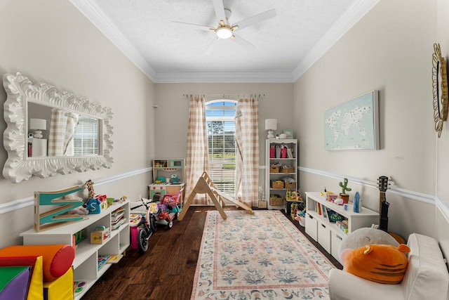 rec room featuring ornamental molding, a textured ceiling, and dark wood-type flooring