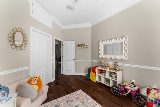 rec room with crown molding and dark hardwood / wood-style flooring