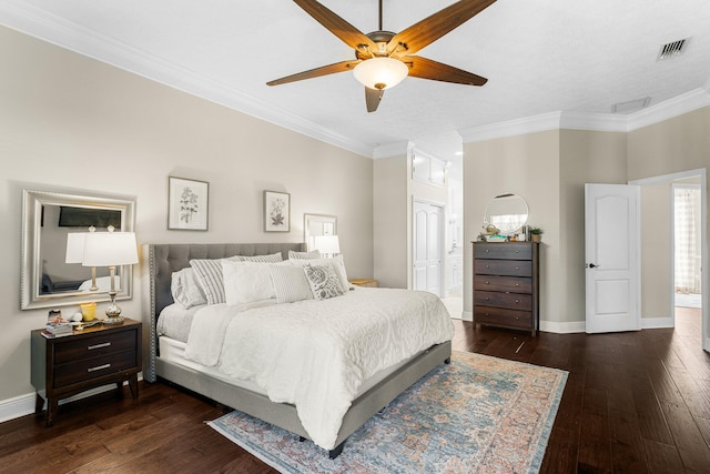 bedroom with ornamental molding, ceiling fan, connected bathroom, and dark hardwood / wood-style flooring