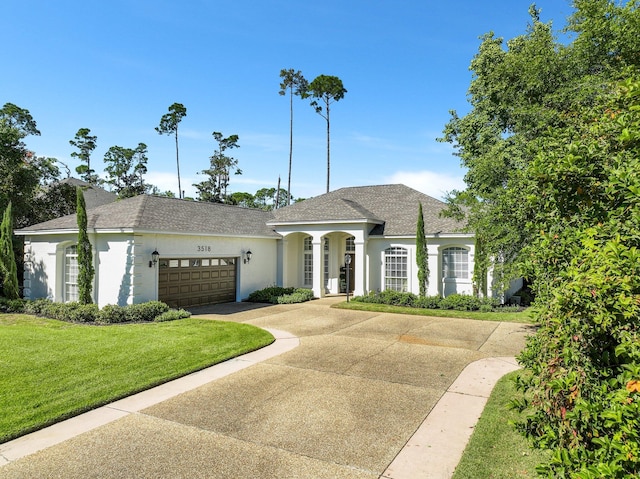 view of front facade with a front yard and a garage