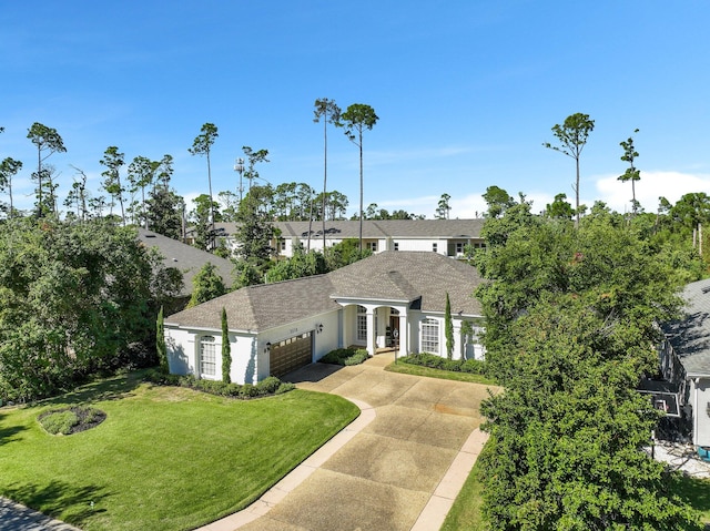 view of front of house with a front yard and a garage