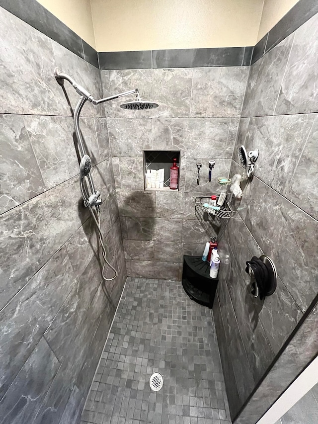 bathroom with a tile shower