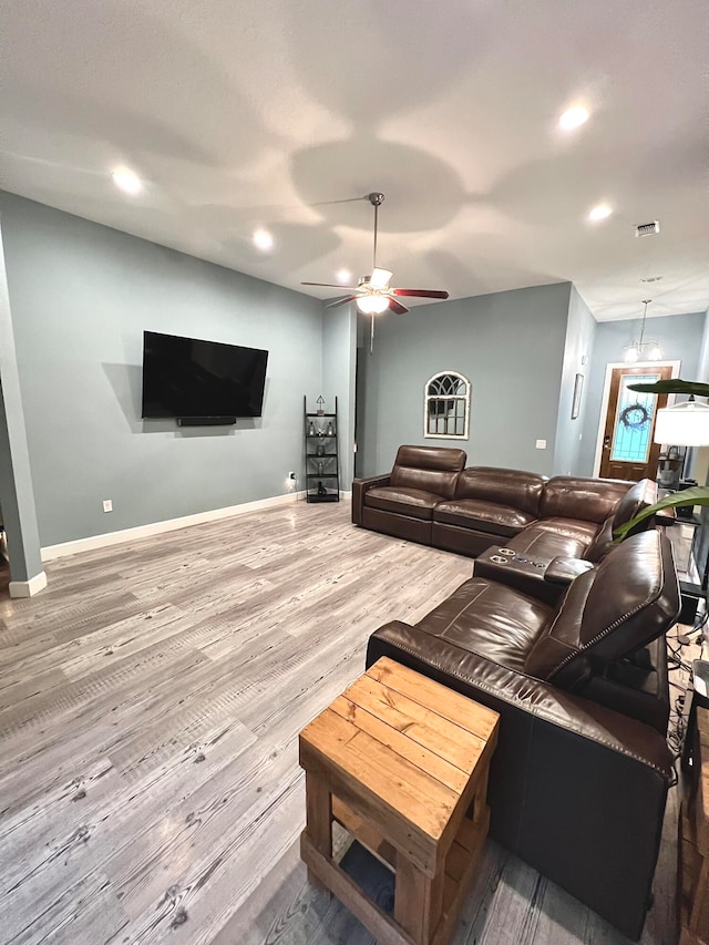 living room with ceiling fan and hardwood / wood-style flooring