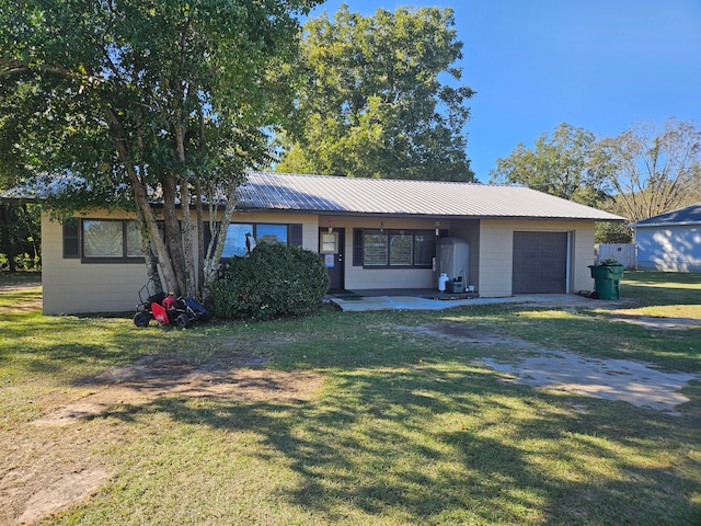 single story home featuring a front yard and a garage