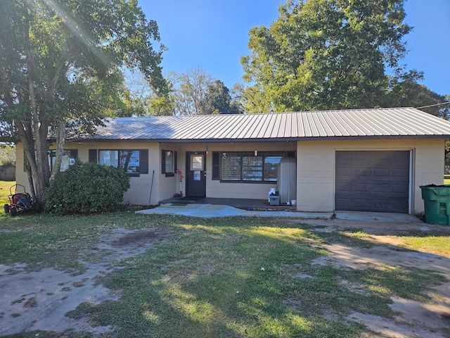 single story home featuring a front yard and a garage