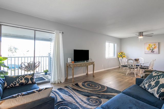 living room featuring hardwood / wood-style floors and ceiling fan