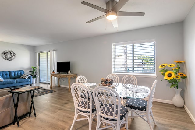 dining room with light hardwood / wood-style flooring and ceiling fan